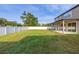 Expansive backyard featuring a large lawn area, a white fence line, and a covered patio at 305 Kays Landing Dr, Sanford, FL 32771