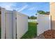 Open white fence gate allows entry to backyard, the mulch bed area around the home at 305 Kays Landing Dr, Sanford, FL 32771