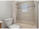 Well lit bathroom featuring tiled walls, a shower with a curtain and an above-the-tub window at 305 Kays Landing Dr, Sanford, FL 32771