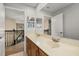 Well-lit bathroom featuring dual sinks with wood cabinets, a large mirror, and tile floors at 305 Kays Landing Dr, Sanford, FL 32771