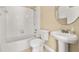 Bathroom features tiled bathtub/shower combination and pedestal sink at 305 Kays Landing Dr, Sanford, FL 32771