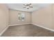 Bright bedroom features a ceiling fan and hardwood floors, capturing cozy comfort at 305 Kays Landing Dr, Sanford, FL 32771