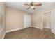 Bedroom featuring wood-look floors, ceiling fan, and door to an additional room at 305 Kays Landing Dr, Sanford, FL 32771