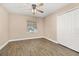 Bedroom features neutral walls, ceiling fan, and light gray wood-look floors at 305 Kays Landing Dr, Sanford, FL 32771