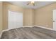 Bedroom features wood-look floors and double door closet at 305 Kays Landing Dr, Sanford, FL 32771