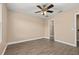 This bright bedroom features a ceiling fan and hardwood floors, capturing cozy comfort at 305 Kays Landing Dr, Sanford, FL 32771