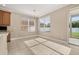 Bright breakfast nook bathed in sunlight with tile flooring and sliding door access to backyard at 305 Kays Landing Dr, Sanford, FL 32771
