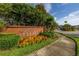 The community sign is nestled in vibrant foliage, welcoming residents and visitors alike at 305 Kays Landing Dr, Sanford, FL 32771