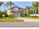 Tan two story home with mature landscaping and a two car garage at 305 Kays Landing Dr, Sanford, FL 32771