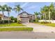 Two story home featuring mature landscaping, palm trees and a two car garage at 305 Kays Landing Dr, Sanford, FL 32771