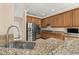 Beautiful kitchen featuring stainless steel appliances, granite countertops, and wooden cabinets at 305 Kays Landing Dr, Sanford, FL 32771