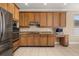 Spacious kitchen boasts stainless appliances, wooden cabinetry, and a convenient workspace at 305 Kays Landing Dr, Sanford, FL 32771
