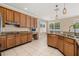 Open kitchen featuring granite countertops, wooden cabinetry, and modern stainless steel sink fixtures at 305 Kays Landing Dr, Sanford, FL 32771