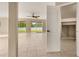 Bright, tiled living room with a ceiling fan and large glass sliding doors to the backyard at 305 Kays Landing Dr, Sanford, FL 32771