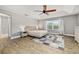 The main bedroom features an elegant tray ceiling, wood-look floors and a large window at 305 Kays Landing Dr, Sanford, FL 32771
