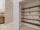 Pantry with custom shelving and lighting for organized storage at 305 Kays Landing Dr, Sanford, FL 32771