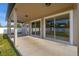 The covered patio offers a seamless indoor-outdoor transition through large glass sliding doors, perfect for entertaining and relaxing at 305 Kays Landing Dr, Sanford, FL 32771