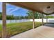 An outdoor patio features a well-maintained lawn, a white fence, and a covered area for relaxing and enjoying the view at 305 Kays Landing Dr, Sanford, FL 32771