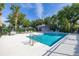 Community pool with a clubhouse, lounge chairs, and lush tropical landscaping at 305 Kays Landing Dr, Sanford, FL 32771