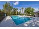 Community pool with crystal-clear water surrounded by lounge chairs and tropical landscaping at 305 Kays Landing Dr, Sanford, FL 32771