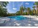 Relaxing community pool with lounge chairs and lush tropical landscaping creating a private oasis at 305 Kays Landing Dr, Sanford, FL 32771