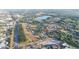 Expansive aerial view of a residential area with a lake and highway nearby at 312 Oak Track Ter, Ocala, FL 34472