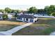 Aerial view of a cozy home with an inviting driveway and a lush green neighborhood at 312 Oak Track Ter, Ocala, FL 34472