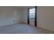 Bright bedroom with light-toned vinyl floors and a window allowing natural light at 312 Oak Track Ter, Ocala, FL 34472