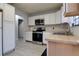 The kitchen features white cabinets, butcher block countertops, modern appliances, and updated vinyl floors at 312 Oak Track Ter, Ocala, FL 34472