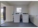 Functional laundry room with modern washer and dryer units, ample lighting, and easy access at 312 Oak Track Ter, Ocala, FL 34472