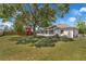 Large backyard with a screened-in lanai and a charming red playhouse, perfect for outdoor relaxation and play at 3205 Clewiston St, Deltona, FL 32738