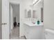 Bathroom with white vanity and view to hall at 3205 Clewiston St, Deltona, FL 32738