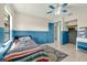 Bedroom with view to closet; color block walls, a ceiling fan, and neutral tile at 3205 Clewiston St, Deltona, FL 32738