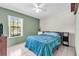 Bedroom with an olive accent wall and a large window at 3205 Clewiston St, Deltona, FL 32738