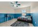 Bedroom with color block walls, a ceiling fan, and natural light from the window at 3205 Clewiston St, Deltona, FL 32738