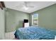Bedroom with neutral walls, a green accent wall, and a window at 3205 Clewiston St, Deltona, FL 32738