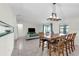 Well-lit dining area with a large wood table, seating for six, and views into the living room at 3205 Clewiston St, Deltona, FL 32738
