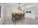 Bright dining area with a wooden table set, ceramic tile flooring, and neutral wall colors at 3205 Clewiston St, Deltona, FL 32738