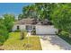 Charming single-story home with a well-manicured lawn and mature trees, providing shade and curb appeal at 3205 Clewiston St, Deltona, FL 32738