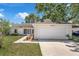 Well-maintained home with a two-car garage, landscaped front yard, and classic curb appeal in a desirable location at 3205 Clewiston St, Deltona, FL 32738