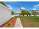 Inviting front yard with mulch filled flower beds and a walkway leading to the home at 3205 Clewiston St, Deltona, FL 32738