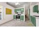 Green kitchen with stainless steel appliances, ceramic tile flooring, and modern fixtures at 3205 Clewiston St, Deltona, FL 32738