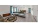 Bright living room with a comfortable gray sectional sofa, decorative rug, and view to dining space at 3205 Clewiston St, Deltona, FL 32738