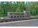 Attractive stone entrance sign of the Wynwood community surrounded by manicured landscaping at 3449 Briarwood Grove Dr, Ocoee, FL 34761