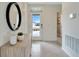 Bright entryway featuring tile floors, a front door with glass, and a round mirror with a console table at 3449 Briarwood Grove Dr, Ocoee, FL 34761