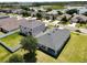 Property showcasing its well-kept lawn, proximity to a tranquil lake and the surrounding residential community at 3702 Maidencain St, Clermont, FL 34714