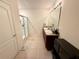 Bathroom featuring a double sink vanity, large mirror, modern fixtures, and a glass-enclosed shower at 3702 Maidencain St, Clermont, FL 34714