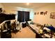 Bedroom featuring carpet flooring, decorative wall art, a gaming chair, a desk, and ample decor at 3702 Maidencain St, Clermont, FL 34714