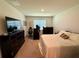 Spacious bedroom with a large window, a comfortable bed, and modern furnishings, creating a relaxing atmosphere at 3702 Maidencain St, Clermont, FL 34714