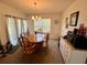 Cozy dining room featuring a wooden table, chandelier, and slider door, perfect for Gathering meals at 3702 Maidencain St, Clermont, FL 34714